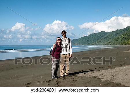 "young travellers on empty beach, wild coast of the Pacific Ocean, Corcovado National Park, Costa Rica,." View Large Photo Image Stock Image - "young travellers on empty beach, wild coast of the Pacific Ocean, Corcovado National Park, Costa Rica,.". Fotosearch