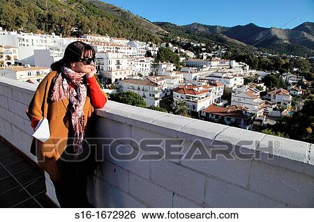 "Young woman admiring the view of a ´white´ touristic village - Mijas Pueblo, Costa del Sol, Andalusia, Spain" View Large Photo Image Stock Photograph - "Young woman admiring the view of a ´white´ touristic village - Mijas Pueblo, Costa del Sol, Andalusia, Spain". Fotosearch