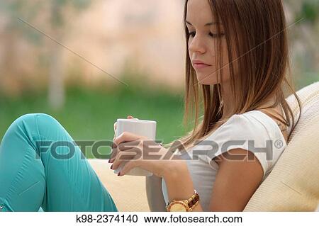 Stock Image - Young woman drinking cofee. Balearic Islands. Spain. Fotosearch