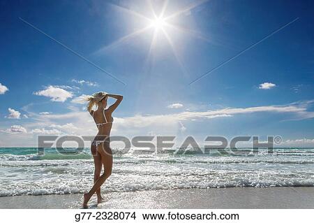Picture - "Young woman on the beach. Miami Beach, Florida, USA". Fotosearch