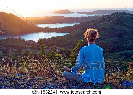 "young woman relaxing on Mount Passot at sunset, Nosy Be island, Republic of Madagascar, Indian Ocean" View Large Photo Image Stock Image - "young woman relaxing on Mount Passot at sunset, Nosy Be island, Republic of Madagascar, Indian Ocean". Fotosearch