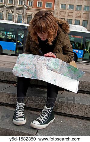 "young woman studing the map on the street, actually in Madrid, Spain" View Large Photo Image Stock Image - "young woman studing the map on the street, actually in Madrid, Spain". Fotosearch