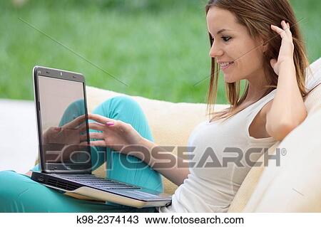 Stock Image - Young woman using laptop. Balearic Islands. Spain. Fotosearch