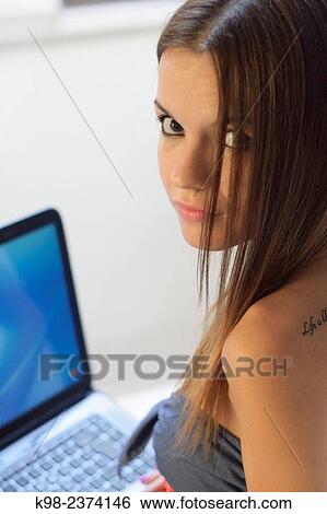 Stock Photograph - Young woman using laptop. Balearic Islands. Spain. Fotosearch