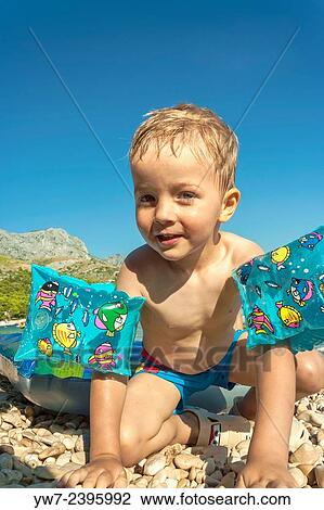 "3 year old boy playing on a beach in Zivogosce, Croatia. " View Large Photo Image Stock Image - "3 year old boy playing on a beach in Zivogosce, Croatia. ". Fotosearch