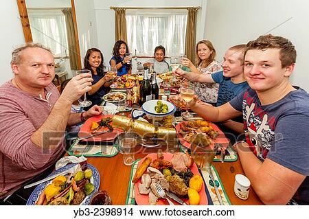 "A Mixed Race Family Enjoying Christmas Lunch, Sussex, England. " View Large Photo Image Picture - "A Mixed Race Family Enjoying Christmas Lunch, Sussex, England. ". Fotosearch