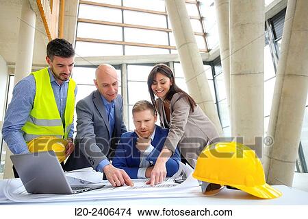 Architects looking at blueprints View Large Photo Image Picture - Architects looking at blueprints. Fotosearch