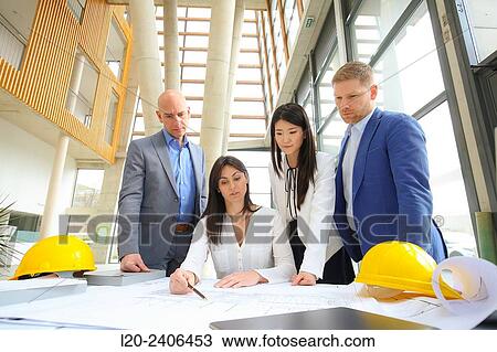 Architects looking at blueprints View Large Photo Image Stock Image - Architects looking at blueprints. Fotosearch