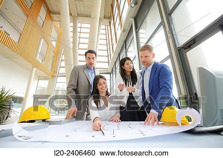 Architects looking at blueprints View Large Photo Image Stock Image - Architects looking at blueprints. Fotosearch