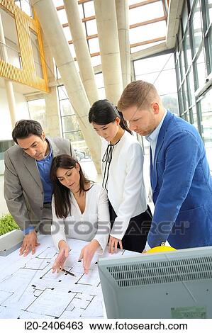 Architects looking at blueprints View Large Photo Image Stock Image - Architects looking at blueprints. Fotosearch