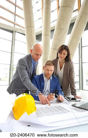 Architects looking at blueprints View Large Photo Image Stock Image - Architects looking at blueprints. Fotosearch