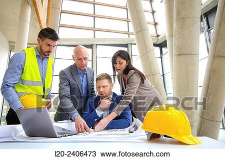 Architects looking at blueprints View Large Photo Image Stock Image - Architects looking at blueprints. Fotosearch