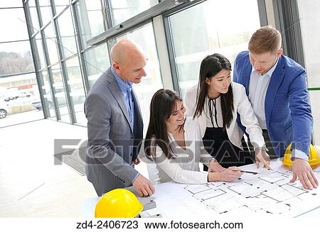 Architects looking at blueprints View Large Photo Image Stock Image - Architects looking at blueprints. Fotosearch