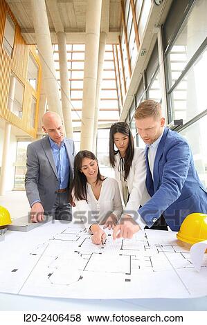 Architects looking at blueprints View Large Photo Image Stock Photo - Architects looking at blueprints. Fotosearch