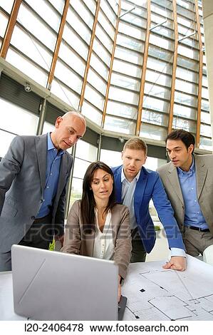 Architects looking at blueprints View Large Photo Image Stock Photo - Architects looking at blueprints. Fotosearch