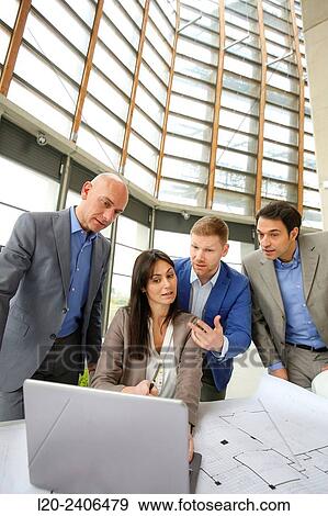 Architects looking at blueprints View Large Photo Image Stock Photo - Architects looking at blueprints. Fotosearch