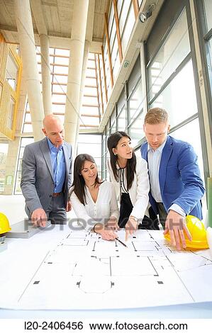 Architects looking at blueprints View Large Photo Image Stock Photograph - Architects looking at blueprints. Fotosearch
