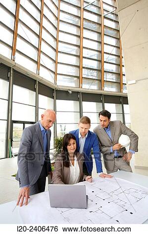 Architects looking at blueprints View Large Photo Image Stock Photograph - Architects looking at blueprints. Fotosearch
