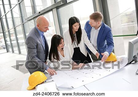 Architects looking at blueprints View Large Photo Image Stock Photograph - Architects looking at blueprints. Fotosearch