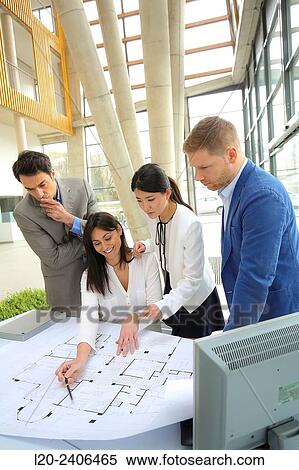 Architects looking at blueprints View Large Photo Image Stock Photography - Architects looking at blueprints. Fotosearch