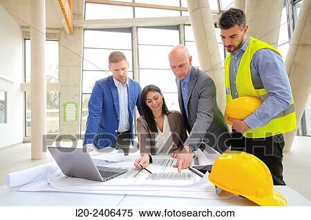 Architects looking at blueprints View Large Photo Image Stock Photography - Architects looking at blueprints. Fotosearch