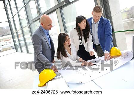 Architects looking at blueprints View Large Photo Image Stock Photography - Architects looking at blueprints. Fotosearch