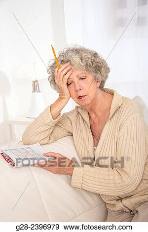 "Beautiful senior woman fallen asleep for an afternoon nap, with a sudoku magazine, and her pen in her hand" View Large Photo Image Stock Photo - "Beautiful senior woman fallen asleep for an afternoon nap, with a sudoku magazine, and her pen in her hand". Fotosearch