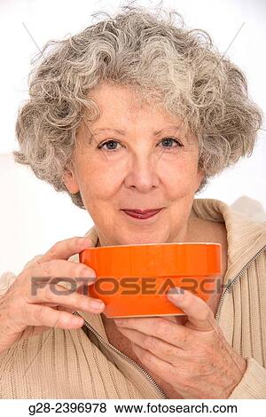 "Beautiful senior woman, holding an orange bowl and smiling, at home" View Large Photo Image Stock Photo - "Beautiful senior woman, holding an orange bowl and smiling, at home". Fotosearch