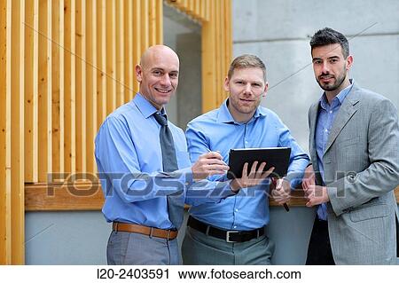 Stock Image - Business men with tablet. Fotosearch