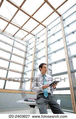 Businessman with digital tablet View Large Photo Image Stock Photo - Businessman with digital tablet. Fotosearch