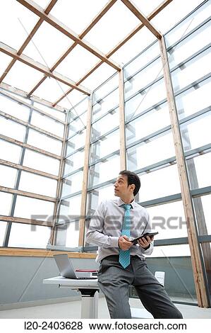 Stock Photo - Businessman with digital tablet. Fotosearch