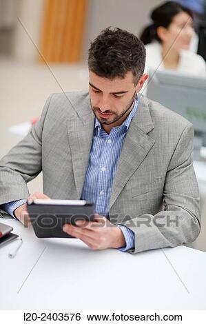 Stock Photograph - Businessman with digital tablet. Fotosearch