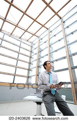 Stock Photograph - Businessman with digital tablet. Fotosearch