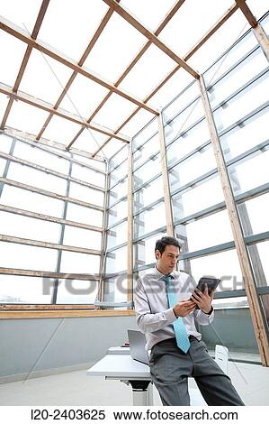 Stock Photography - Businessman with digital tablet. Fotosearch