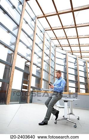 Stock Image - Businessman with smartphone. Fotosearch