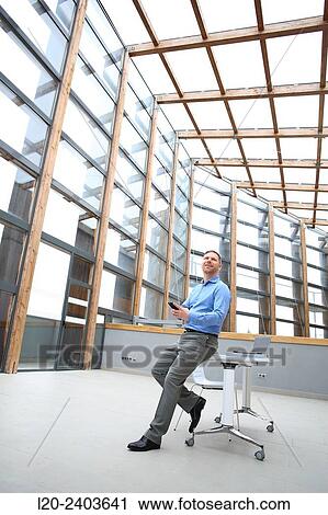 Stock Image - Businessman with smartphone. Fotosearch