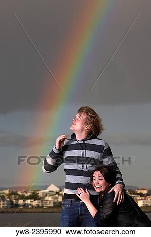 Stock Image - "Couple with arctic terns and rainbow, Reykjavik, Iceland. ". Fotosearch