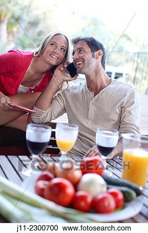 Couple with cell phone and digital tablet View Large Photo Image Stock Image - Couple with cell phone and digital tablet. Fotosearch