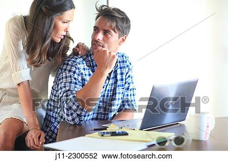 Stock Image - Couple working with laptop. Fotosearch