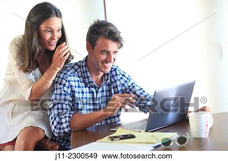 Couple working with laptop View Large Photo Image Stock Photo - Couple working with laptop. Fotosearch