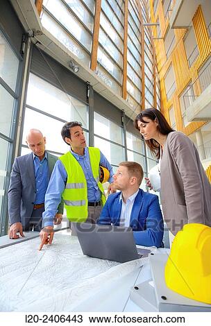 Stock Image - Engineers looking at map. Fotosearch