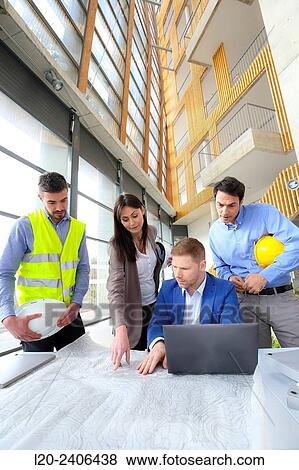 Engineers looking at map View Large Photo Image Stock Photo - Engineers looking at map. Fotosearch
