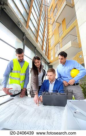 Engineers looking at map View Large Photo Image Stock Photo - Engineers looking at map. Fotosearch