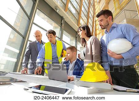 Engineers looking at map View Large Photo Image Stock Photo - Engineers looking at map. Fotosearch