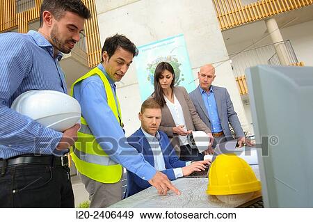 Engineers looking at map View Large Photo Image Stock Photo - Engineers looking at map. Fotosearch