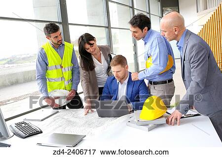 Engineers looking at map View Large Photo Image Stock Photo - Engineers looking at map. Fotosearch