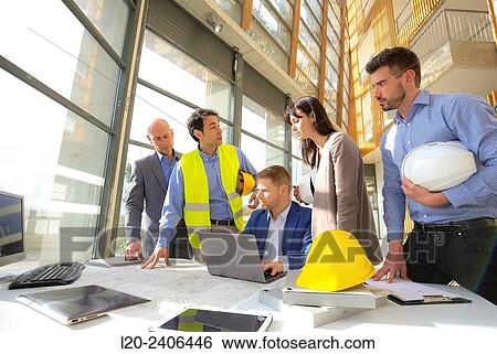 Engineers looking at map View Large Photo Image Stock Photograph - Engineers looking at map. Fotosearch