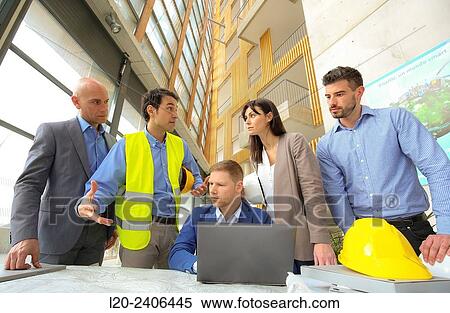 Stock Photography - Engineers looking at map. Fotosearch