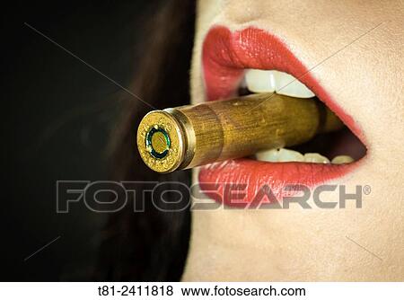 "Girl biting a bullet, studio, Valencia" View Large Photo Image Stock Photo - "Girl biting a bullet, studio, Valencia". Fotosearch