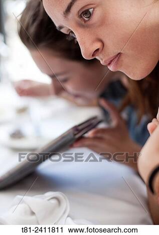 "girls looking at a tablet in Benidorm, Spain" View Large Photo Image Stock Image - "girls looking at a tablet in Benidorm, Spain". Fotosearch